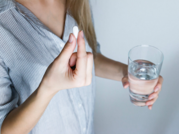 a person taking a pill