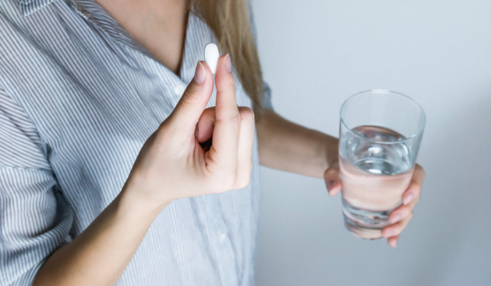 a person taking a pill