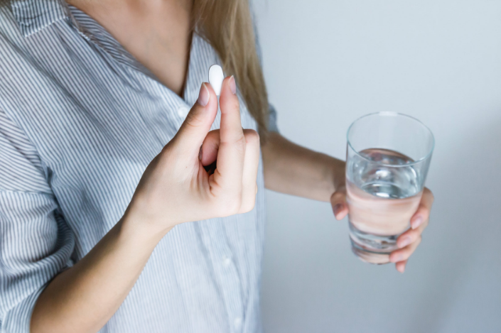 a person taking a pill