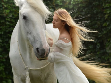 a white horse and a lady in white