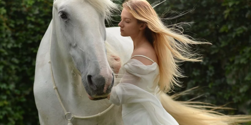 a white horse and a lady in white